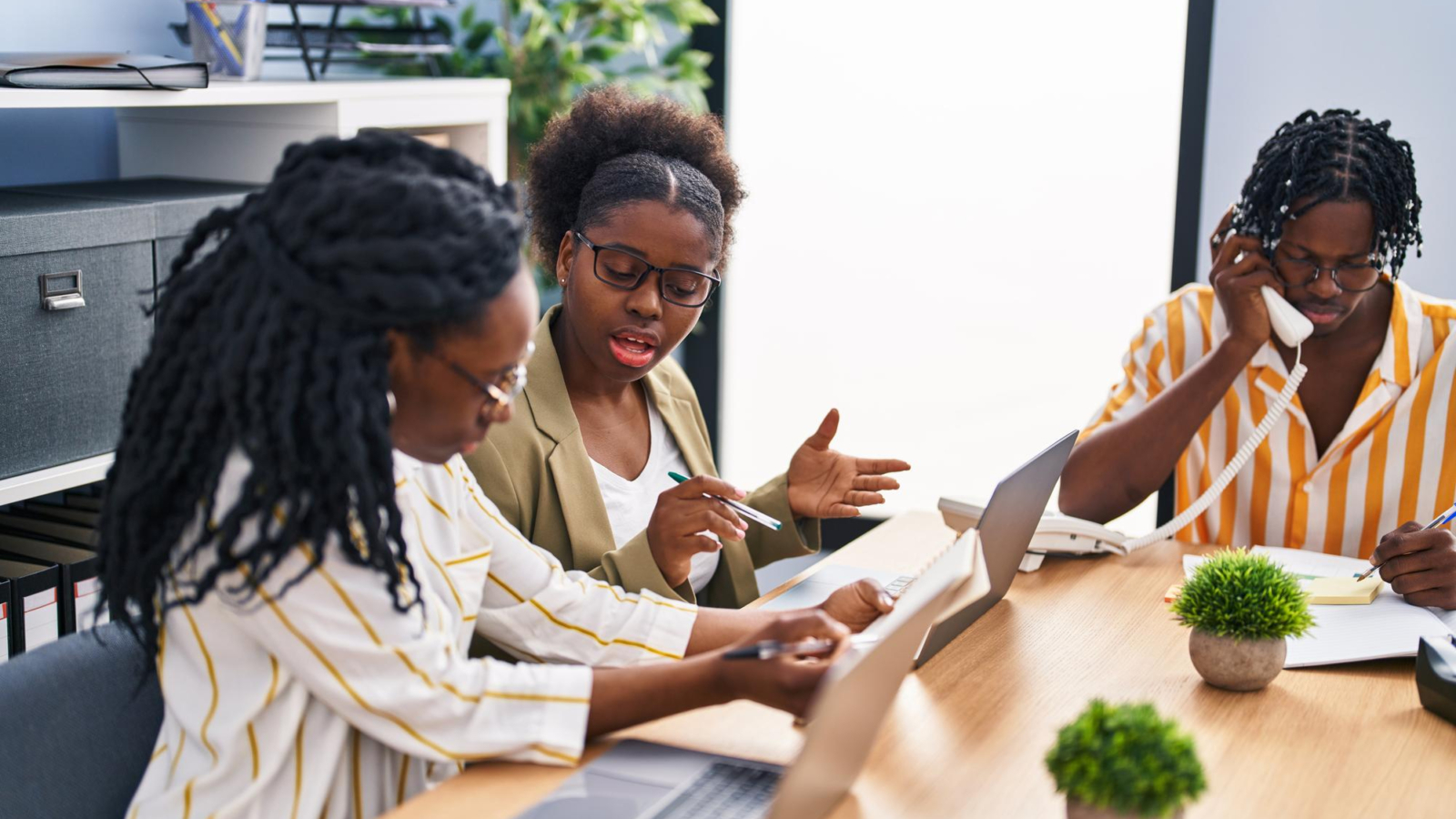 african-american-friends-business-workers-sitting-table-working-office