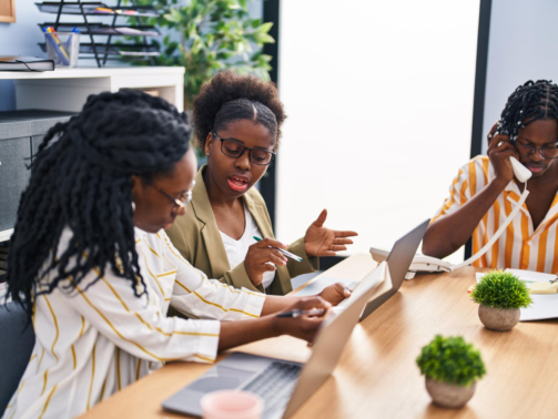 african-american-friends-business-workers-sitting-table-working-office